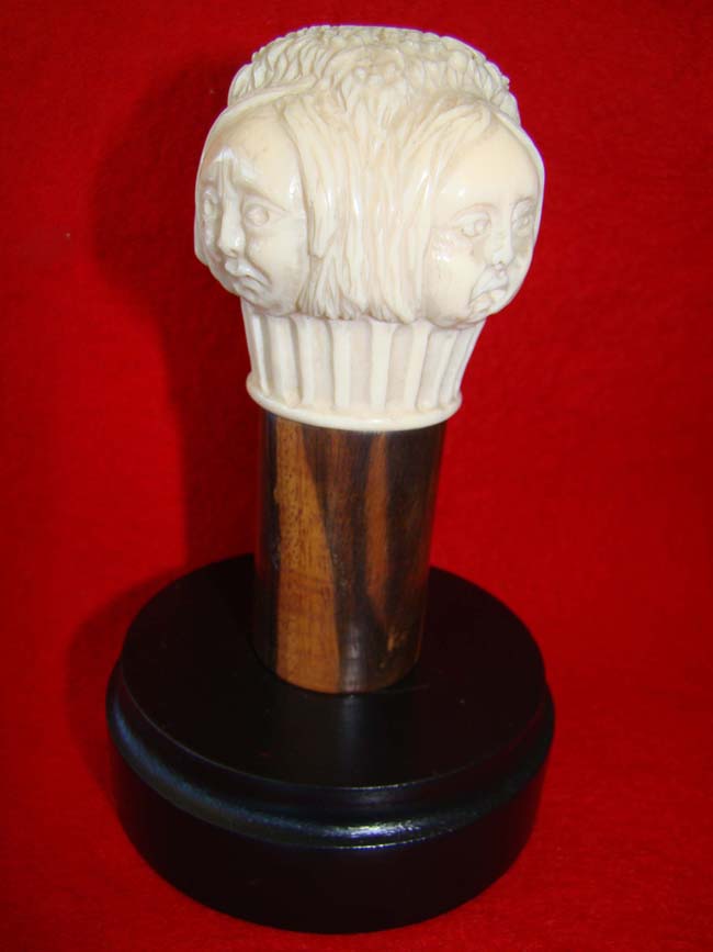 A rare carved four sided ivory knob from a cane with each side depicting the face of a woman with a different expressions. American circa 1850-1875